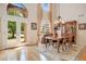 Elegant dining room with hardwood floors, chandelier lighting, and large windows for natural light at 14244 Nottingham Way Cir, Orlando, FL 32828
