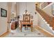 Dining area with a staircase, featuring hardwood floors, chandelier lighting, and staircase at 14244 Nottingham Way Cir, Orlando, FL 32828
