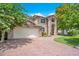 Beautiful home with manicured landscaping, brick driveway and a two-car garage with brick accents at 14244 Nottingham Way Cir, Orlando, FL 32828