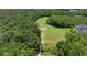 Overhead view of golf course winding through mature trees and lush landscaping in this lovely community at 14244 Nottingham Way Cir, Orlando, FL 32828