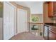 Upstairs hallway with carpet, neutral walls, half moon window and wrought iron railing overlooking the lower level at 14244 Nottingham Way Cir, Orlando, FL 32828