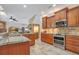 Open-concept kitchen featuring stainless steel appliances, granite countertops, and seamless flow to the living area at 14244 Nottingham Way Cir, Orlando, FL 32828