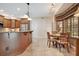 Spacious kitchen featuring granite countertops, wooden cabinets, stainless steel appliances and adjacent breakfast nook at 14244 Nottingham Way Cir, Orlando, FL 32828