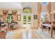 Bright living room features hardwood floors, tall ceilings, large windows with beautiful curtains and decor at 14244 Nottingham Way Cir, Orlando, FL 32828