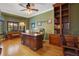 Elegant office with custom built-in shelving, hardwood floors, and ample natural light at 14244 Nottingham Way Cir, Orlando, FL 32828