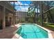 Screened-in pool and spa area with lush landscaping at 14244 Nottingham Way Cir, Orlando, FL 32828