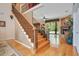 Elegant staircase featuring wood steps, detailed wrought iron railings, and an open view to the living area at 14244 Nottingham Way Cir, Orlando, FL 32828