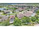 Aerial view of a residential neighborhood featuring a lake and swimming pools at 14342 Fieldstone Lake Way, Orlando, FL 32824