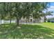 Large backyard with mature tree and swimming pool enclosed by a black metal fence at 14342 Fieldstone Lake Way, Orlando, FL 32824