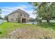 Large backyard features a swimming pool enclosed by black metal fencing and a grassy lawn at 14342 Fieldstone Lake Way, Orlando, FL 32824
