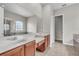 A modern bathroom featuring dual sinks, tile flooring, a large mirror, and a glass-enclosed shower at 14342 Fieldstone Lake Way, Orlando, FL 32824