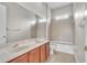 Bathroom with a double vanity, neutral toned tiling, a shower-tub combo, and overhead lighting at 14342 Fieldstone Lake Way, Orlando, FL 32824