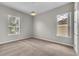 Bedroom with plush carpet, light gray walls, two windows and overhead lighting at 14342 Fieldstone Lake Way, Orlando, FL 32824