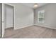 Bright bedroom features neutral carpet, a window with blinds, and a ceiling light at 14342 Fieldstone Lake Way, Orlando, FL 32824