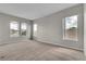 An airy bedroom featuring plush carpeting, neutral walls, and multiple windows providing plenty of natural light at 14342 Fieldstone Lake Way, Orlando, FL 32824