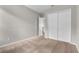 A well lit bedroom with plush carpet, light gray walls, and a double closet at 14342 Fieldstone Lake Way, Orlando, FL 32824