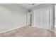 A well lit bedroom with plush carpet, light gray walls, and a double closet at 14342 Fieldstone Lake Way, Orlando, FL 32824