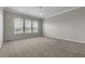 This bedroom is roomy and has soft carpeting and three large windows at 14342 Fieldstone Lake Way, Orlando, FL 32824