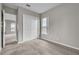 Bedroom with a double closet, light gray walls, plush carpet and a window at 14342 Fieldstone Lake Way, Orlando, FL 32824
