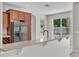 Kitchen featuring stone countertops, stainless steel refrigerator and backyard view from the kitchen at 14342 Fieldstone Lake Way, Orlando, FL 32824