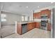 Open kitchen with stainless steel appliances, stone countertops, and tile flooring at 14342 Fieldstone Lake Way, Orlando, FL 32824