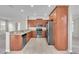 Well-equipped kitchen with stainless steel appliances, breakfast bar, and tile flooring at 14342 Fieldstone Lake Way, Orlando, FL 32824