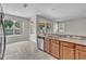 Open-concept kitchen with stainless steel dishwasher and sink looking to the backyard at 14342 Fieldstone Lake Way, Orlando, FL 32824