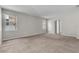 Spacious living room featuring neutral carpet and natural light from two large windows at 14342 Fieldstone Lake Way, Orlando, FL 32824