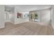 Living room featuring an open layout, kitchen access, and a sliding door to the pool at 14342 Fieldstone Lake Way, Orlando, FL 32824