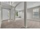 Bright living room featuring neutral paint, carpet, and architectural pillars at 14342 Fieldstone Lake Way, Orlando, FL 32824