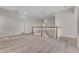Bright loft area features soft carpeting, neutral paint, staircase, and a stylish hanging pendant light at 14342 Fieldstone Lake Way, Orlando, FL 32824