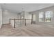 Spacious loft area with neutral walls, carpet, a staircase, and a hanging pendant light fixture at 14342 Fieldstone Lake Way, Orlando, FL 32824