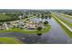 An aerial view of a neighborhood surrounding a serene lake, with a home marked by a location pin at 1606 Burryport Dr, Orlando, FL 32837