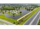 Aerial view of a residential area with a pond and a nearby highway, with a home marked by a location pin at 1606 Burryport Dr, Orlando, FL 32837