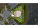 Aerial view of the property showcasing the pool, screened enclosure, lush backyard, and proximity to the serene lake at 1606 Burryport Dr, Orlando, FL 32837