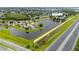 Aerial view of a residential area with a pond and a nearby highway, with a home marked by a location pin at 1606 Burryport Dr, Orlando, FL 32837