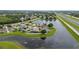An aerial view of a neighborhood surrounding a serene lake, with a home marked by a location pin at 1606 Burryport Dr, Orlando, FL 32837