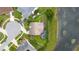 Aerial view of the property showcasing the pool, screened enclosure, lush backyard, and proximity to the serene lake at 1606 Burryport Dr, Orlando, FL 32837