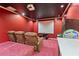 Basement home theater featuring comfortable seating, a projector screen, and arcade games at 1606 Burryport Dr, Orlando, FL 32837