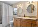 Bathroom with dual sinks, a beige countertop, and a shower tub combination with a white curtain at 1606 Burryport Dr, Orlando, FL 32837