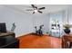 Spacious bedroom with a workstation and plants, featuring hardwood floors and natural light at 1606 Burryport Dr, Orlando, FL 32837