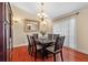 Dining room showcasing a dark wood table with seating for six, hardwood floors, and a decorative light fixture at 1606 Burryport Dr, Orlando, FL 32837