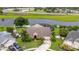 A front aerial view of a single Gathering home shows a large driveway, mature landscaping, and a screened-in lanai at 1606 Burryport Dr, Orlando, FL 32837