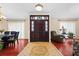 Elegant foyer featuring decorative tile inlay, hardwood flooring, and a solid wood front door with sidelights at 1606 Burryport Dr, Orlando, FL 32837