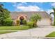 Charming single-Gathering home featuring a well-manicured lawn, mature landscaping, and a classic two-car garage at 1606 Burryport Dr, Orlando, FL 32837