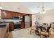Kitchen featuring stainless steel appliances, dark wood cabinets, and an adjacent dining area at 1606 Burryport Dr, Orlando, FL 32837