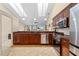 Open concept kitchen with stainless steel appliances, wood cabinetry, and ample counter space at 1606 Burryport Dr, Orlando, FL 32837