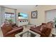 Comfortable living room featuring tile flooring, a large television, and two leather sofas at 1606 Burryport Dr, Orlando, FL 32837