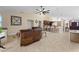 Spacious living room features tile flooring, a dark leather sofa, and an open concept to the kitchen area at 1606 Burryport Dr, Orlando, FL 32837