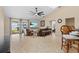 Bright living room with tile flooring, a ceiling fan, and sliding glass doors to a fenced backyard at 1606 Burryport Dr, Orlando, FL 32837